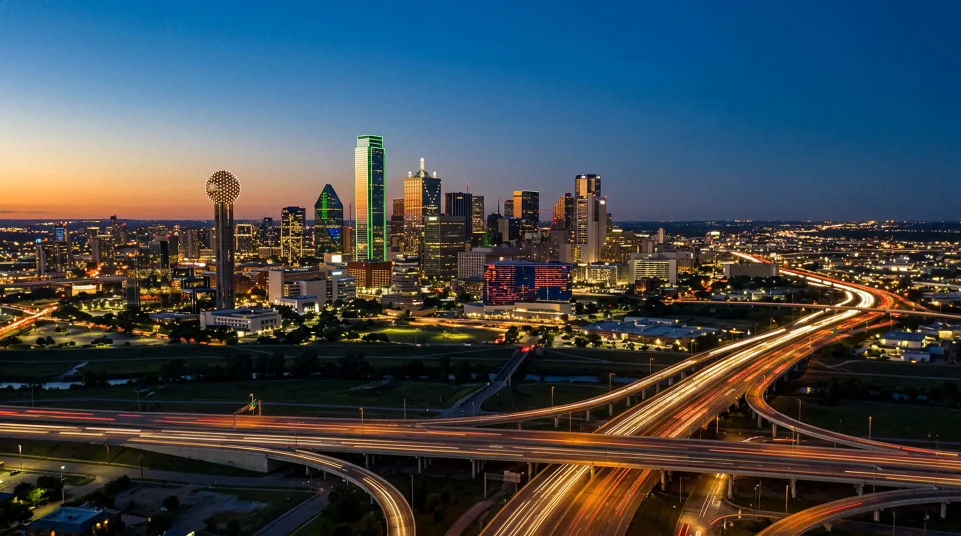 Dallas skyline at dusk with Reunion Tower and highway light trails